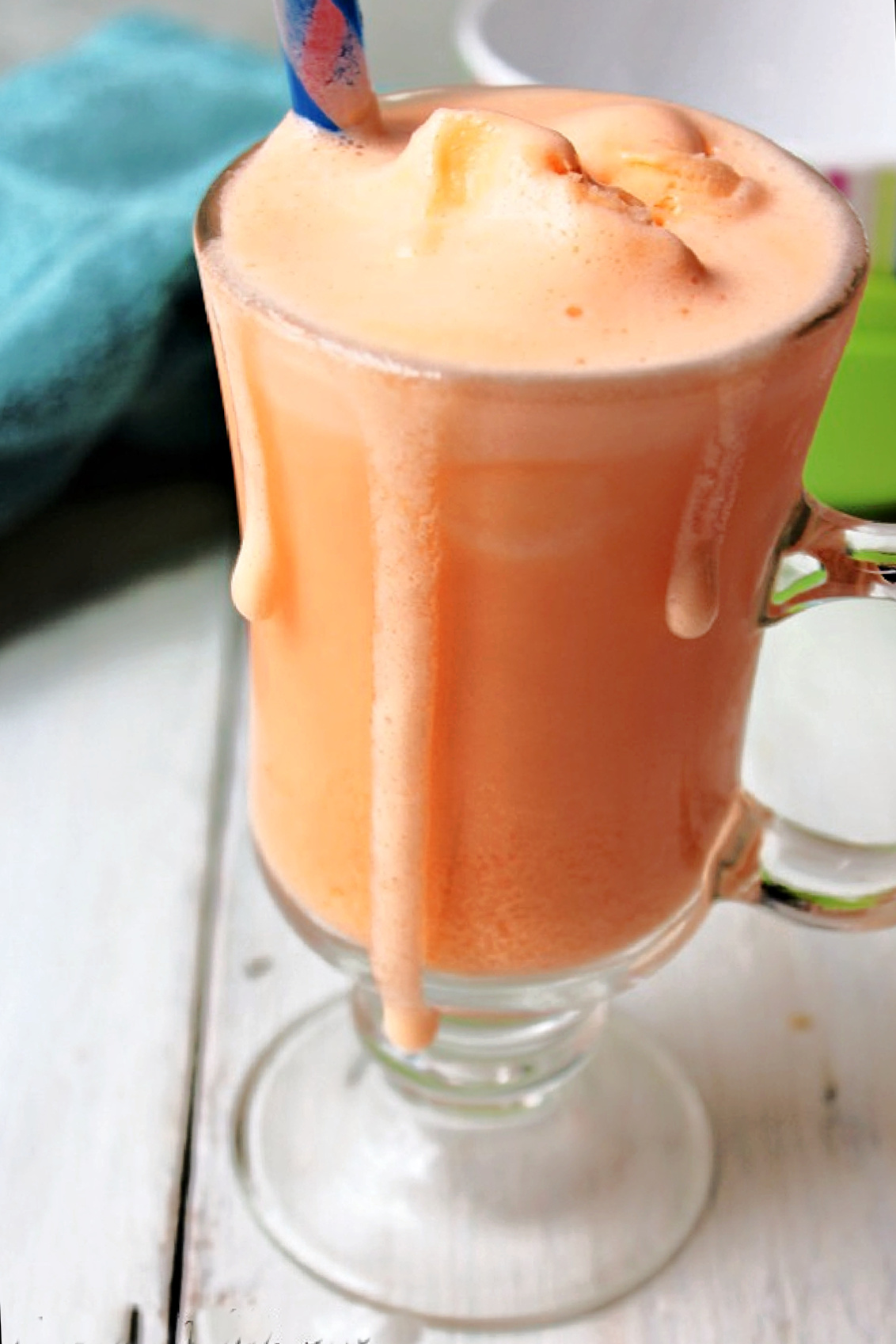a clear glass with orange vanilla frosty inside.