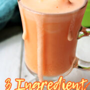 3 ingredient orange vanilla frosty in a clear cup with a straw.