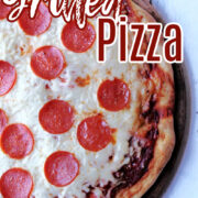 grilled pizza with pepperoni on a stone.