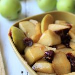 Cinnamon apples with craisins in a brown bowl