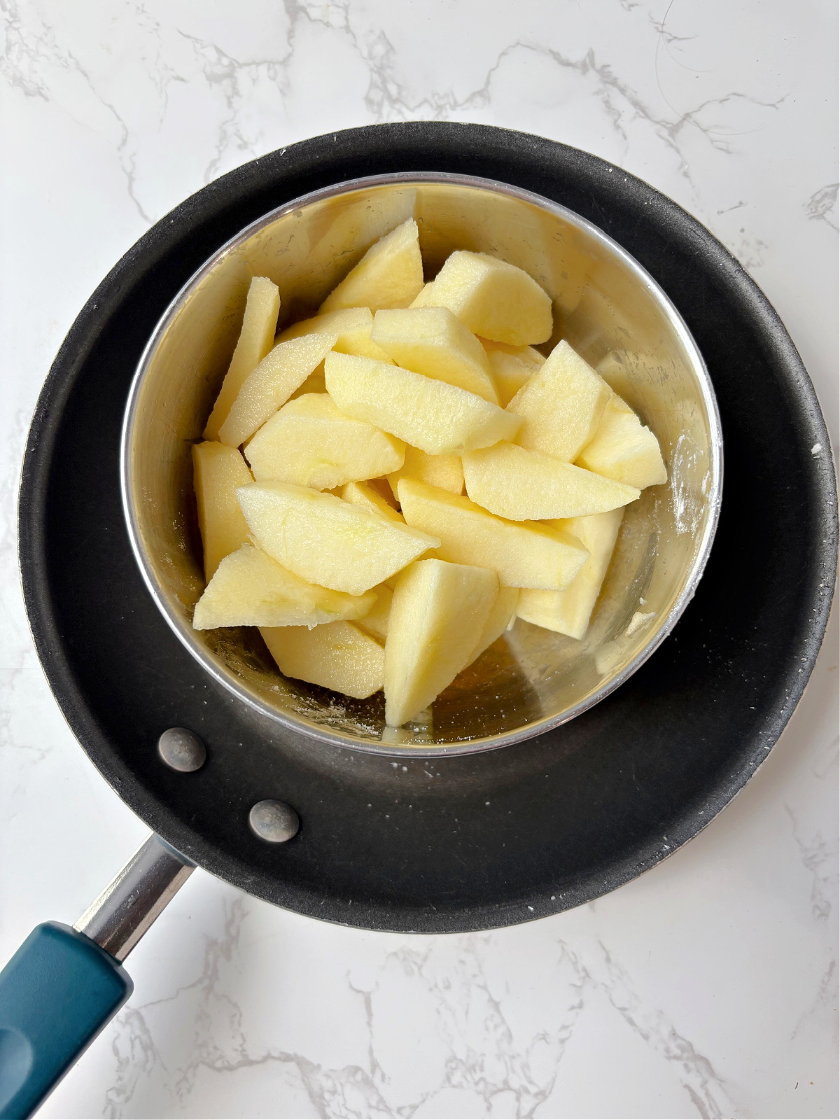 apples in a bowl in a frying pan.