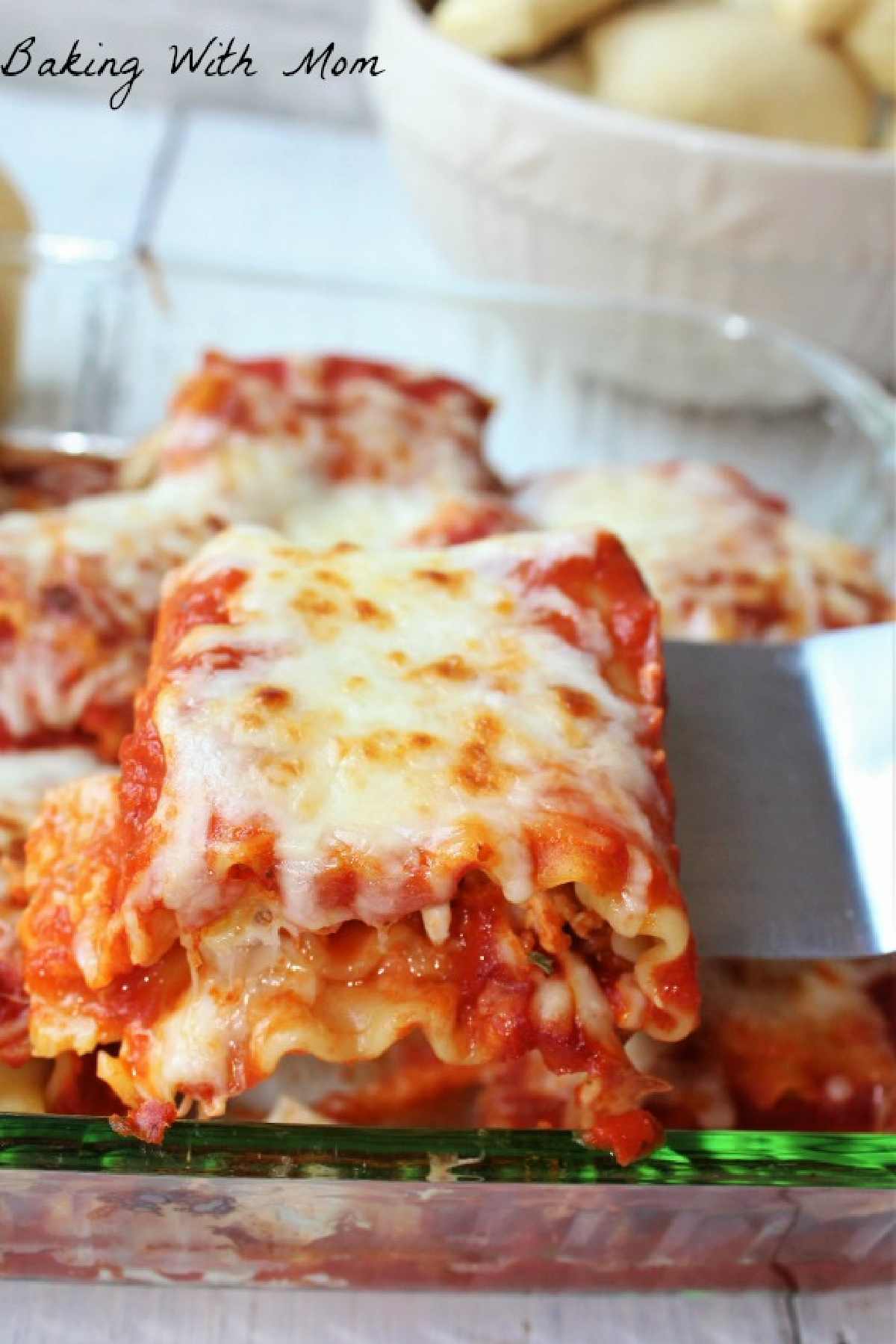 Chicken parmesan roll up in a baking dish. 