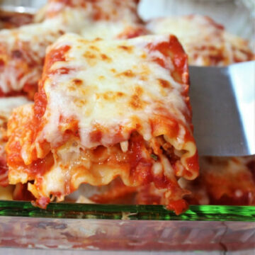 Chicken parmesan roll ups in a baking dish.