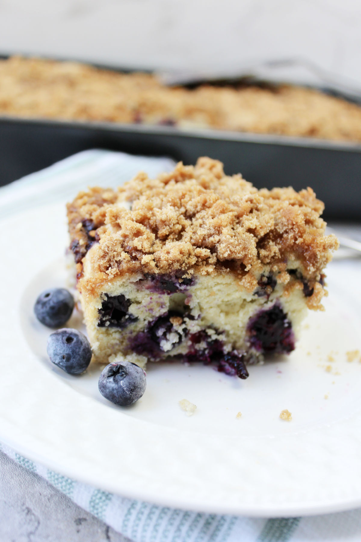Blueberry coffee cake on a white plate.