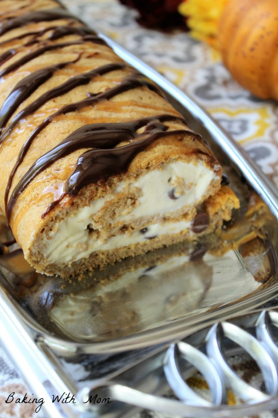 Pumpkin Pie Ice Cream Roll on a silver platter. Chocolate and caramel drizzled on top. 