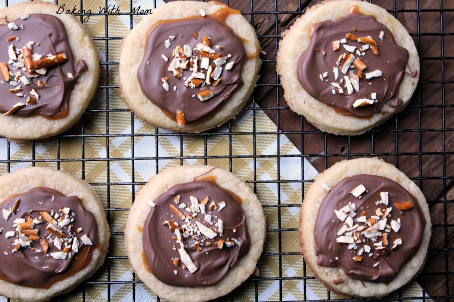 cookies with pretzel bits on top and caramel and chocolate 