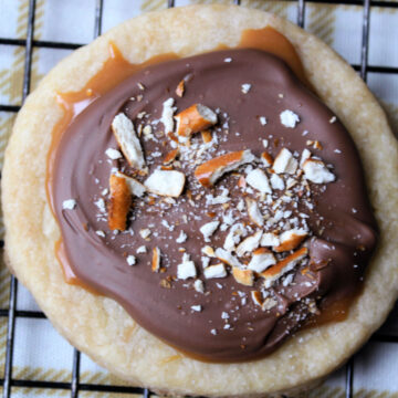 cookie with chocolate and caramel on a cooling rack
