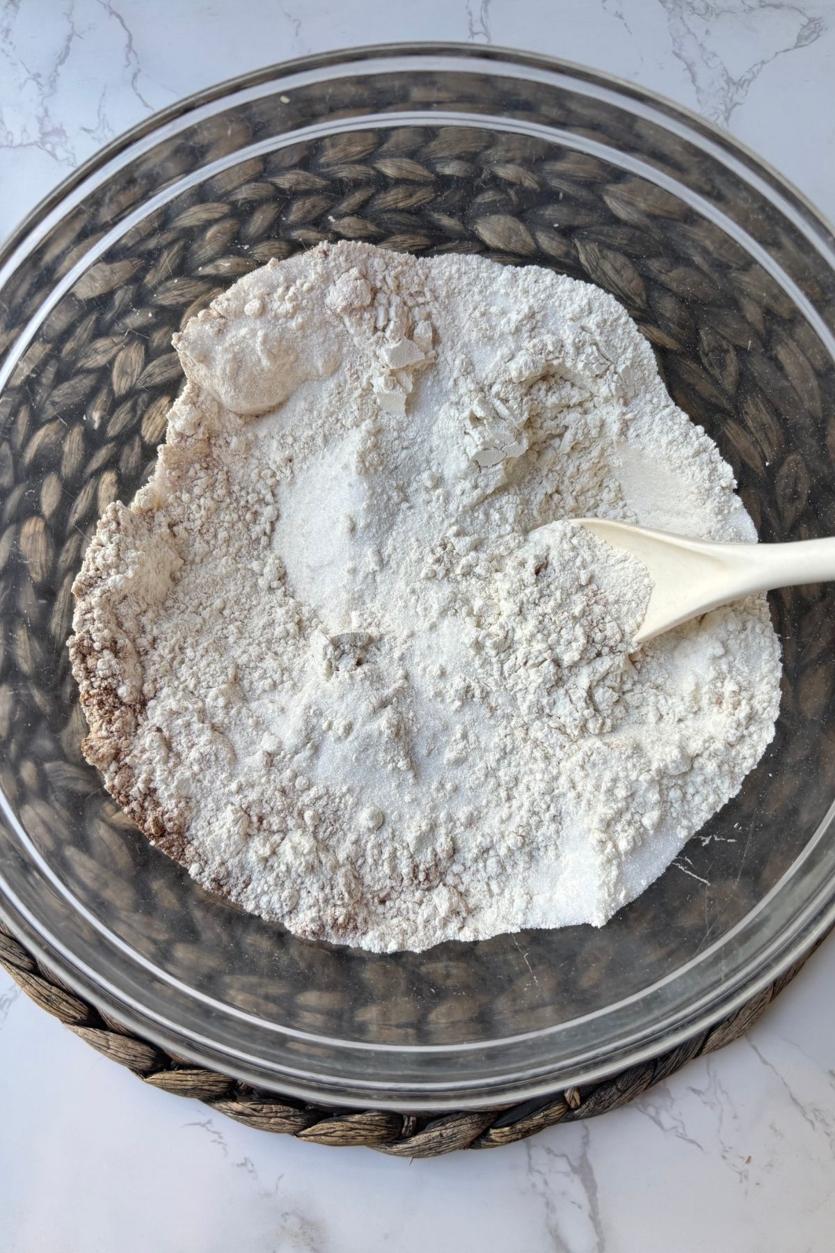 flour in a bowl with a spoon.