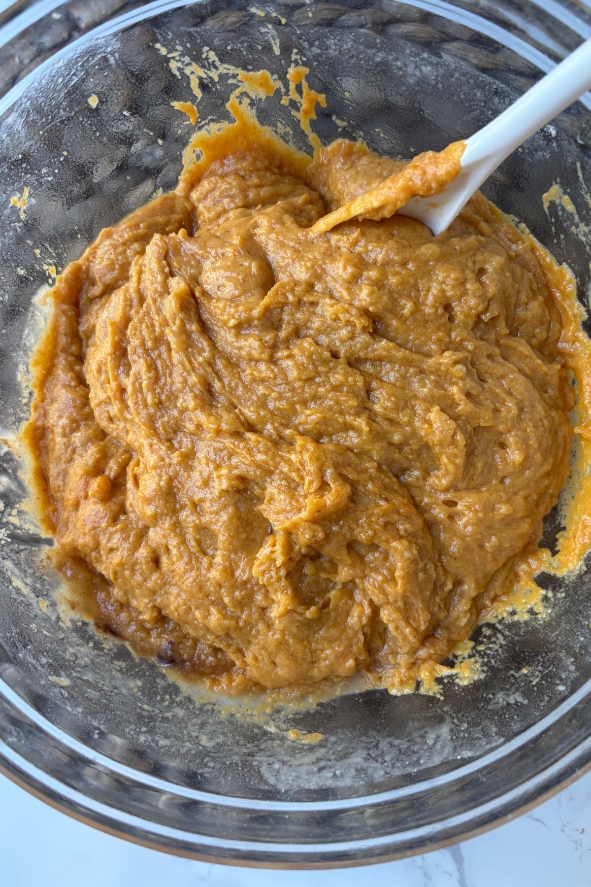pumpkin batter in a clear bowl.