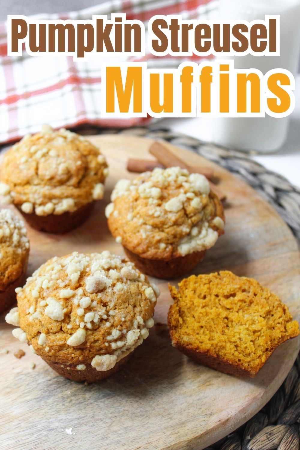 Pumpkin muffins with streusel on a wooden board.