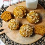 pumpkin muffins with milk behind.
