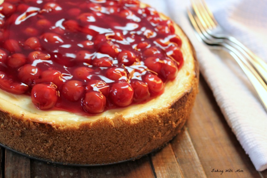 Baked Cherry Cheesecake on a brown wooden board.