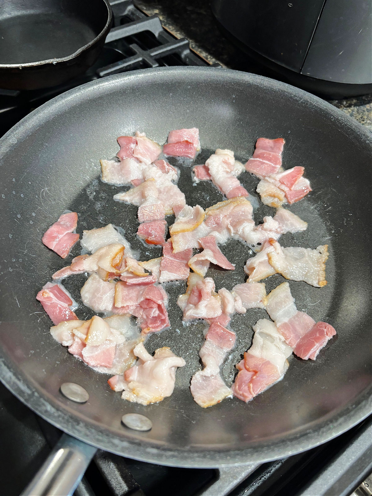 bacon cooking in a frying pan. 