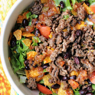 hamburger, tomatoes, lettuce in a white bowl.