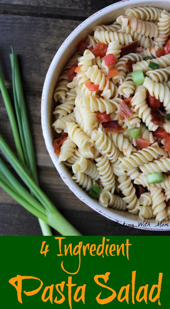 pasta, green onions, tomatoes, bacon in a cream colored bowl on a brown backdrop