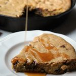 Caramel Chocolate Chip Skillet Cookie with drizzled caramel on top