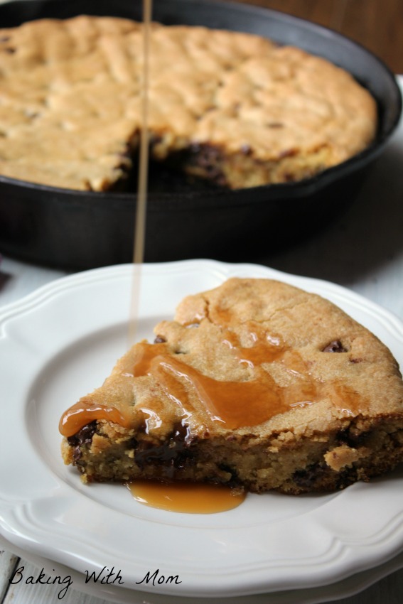 Caramel Chocolate Chip Skillet Cookie with drizzled caramel on top on a white plate