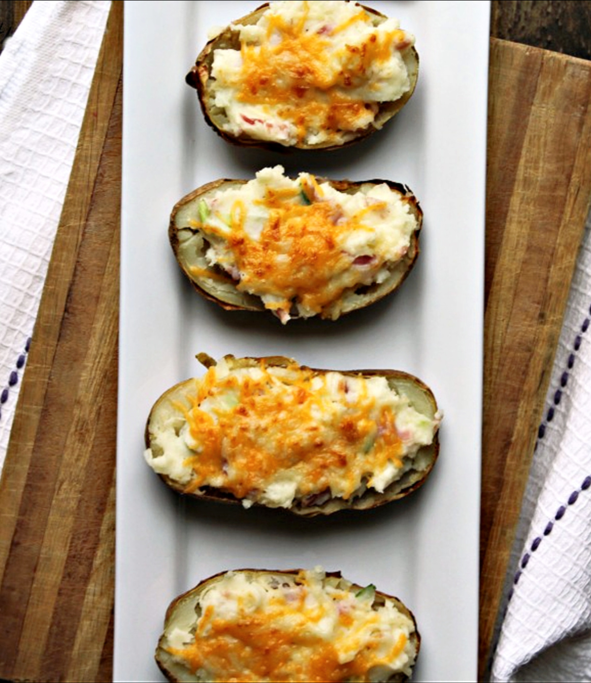twice baked potatoes on a white plate.