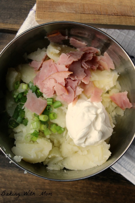 Ham Stuffed Twice Baked Potatoes with sour cream and chopped green onions