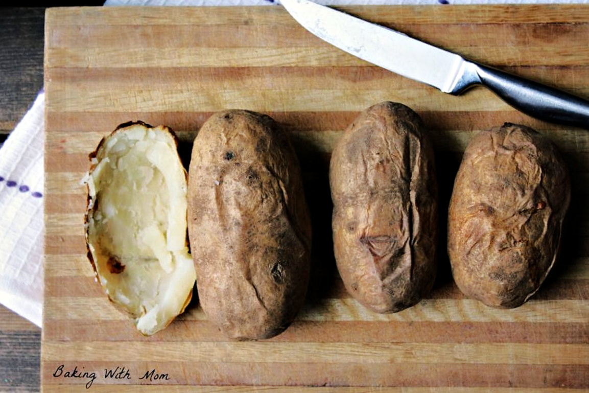 baked potatoes on a cutting board.
