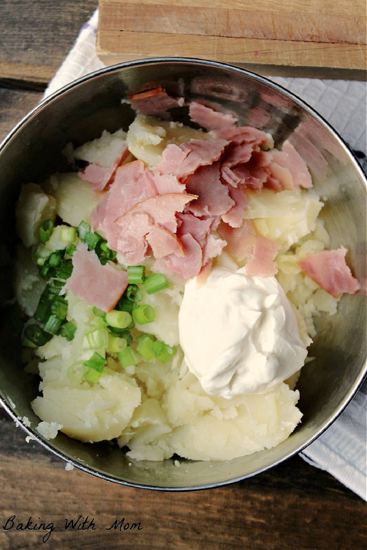 ham, sour cream, potatoes in a bowl. 