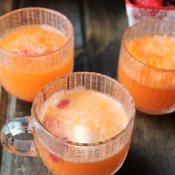 Orange soda with orange cream ice cream and strawberries in glass punch glasses