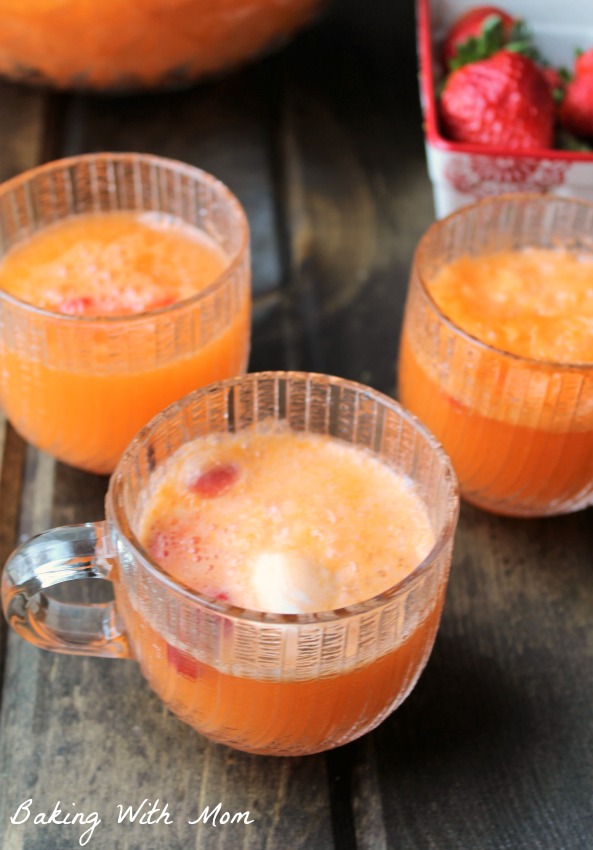 Orange soda with orange cream ice cream and strawberries in glass punch glasses.