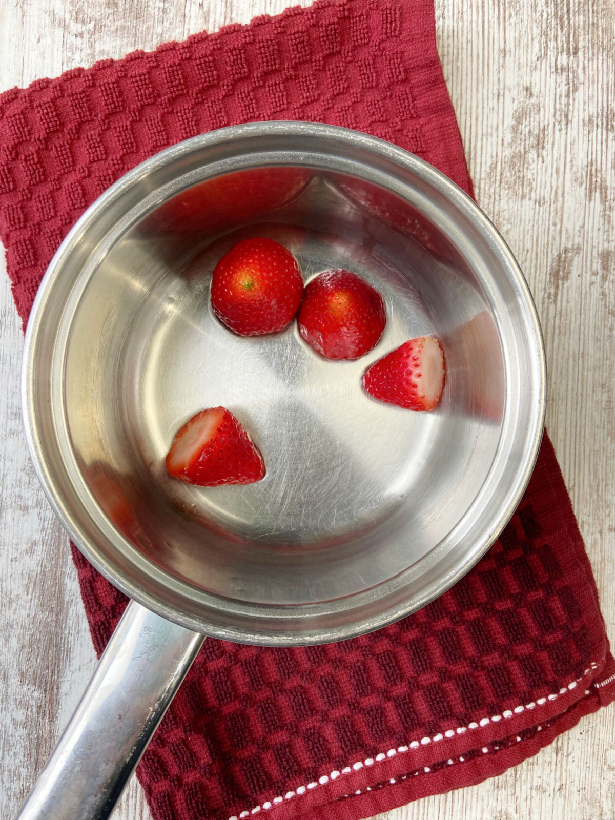 4 strawberries in a saucepan. 