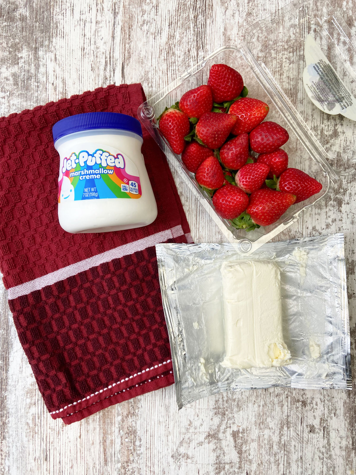 strawberry dip ingredients, cream cheese, marshmallow cream and strawberries. 