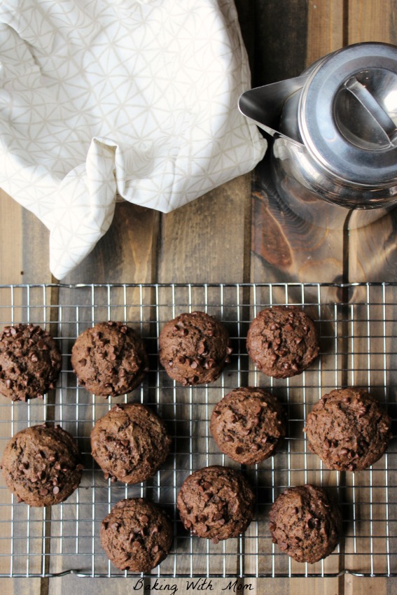 Easy Double Chocolate Chip Muffins next to a bowl and a silver pitcher