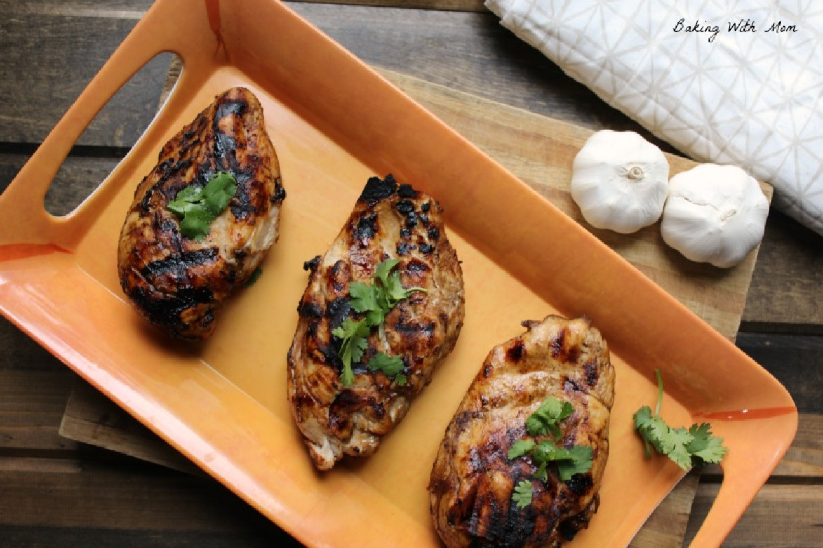 grilled chicken marinade on an orange platter.