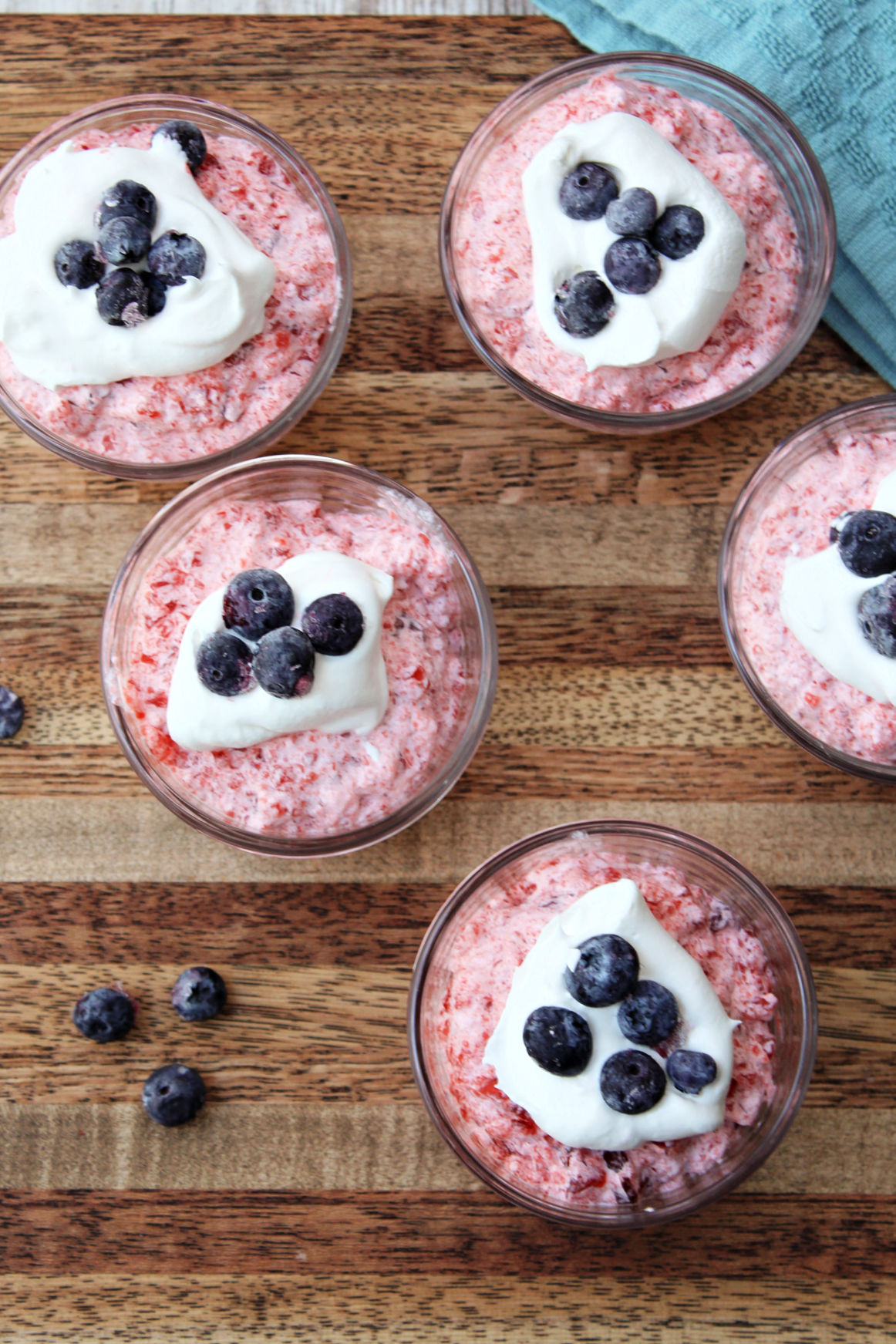 Jello cups with blueberries on top. 