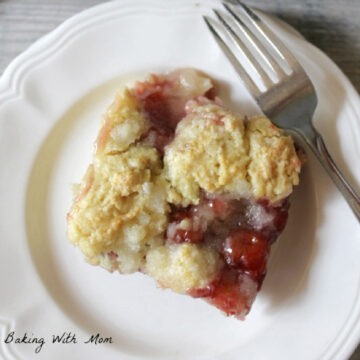 cherry coffee cake on a white plate with a fork