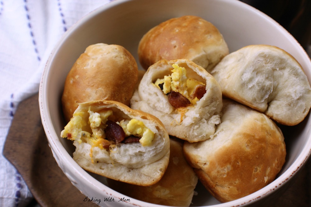 Breakfast Stuffed Biscuits with eggs, bacon, cheese in a cream colored bowl.