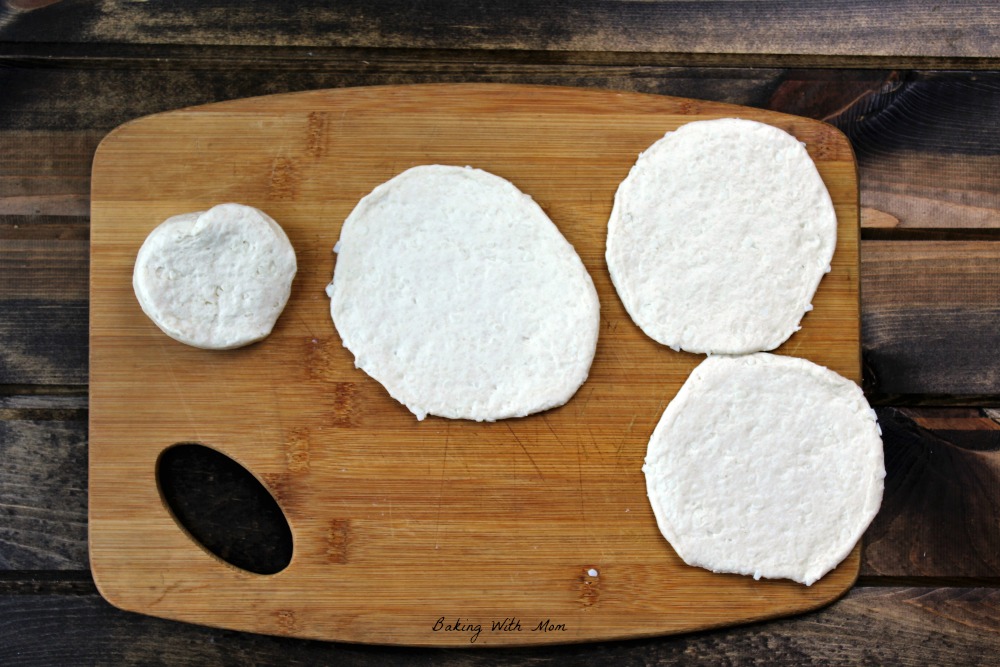 Flattened biscuits on a cutting board