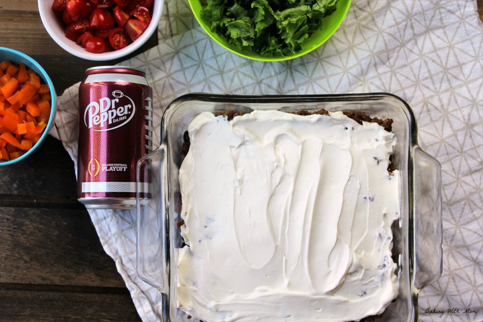 Sour Cream layered on black beans and hamburger