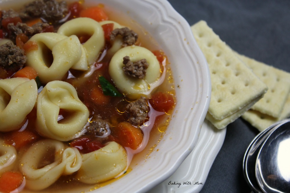 Hamburger Tortellini Soup in a white bowl with crackers