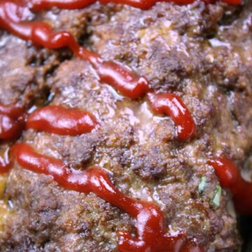 Stuffed Cheesy Meatloaf with ketchup on top