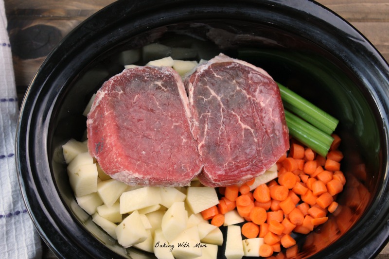 Beef, potatoes, carrots, celery in a crock pot for vegetable beef soup