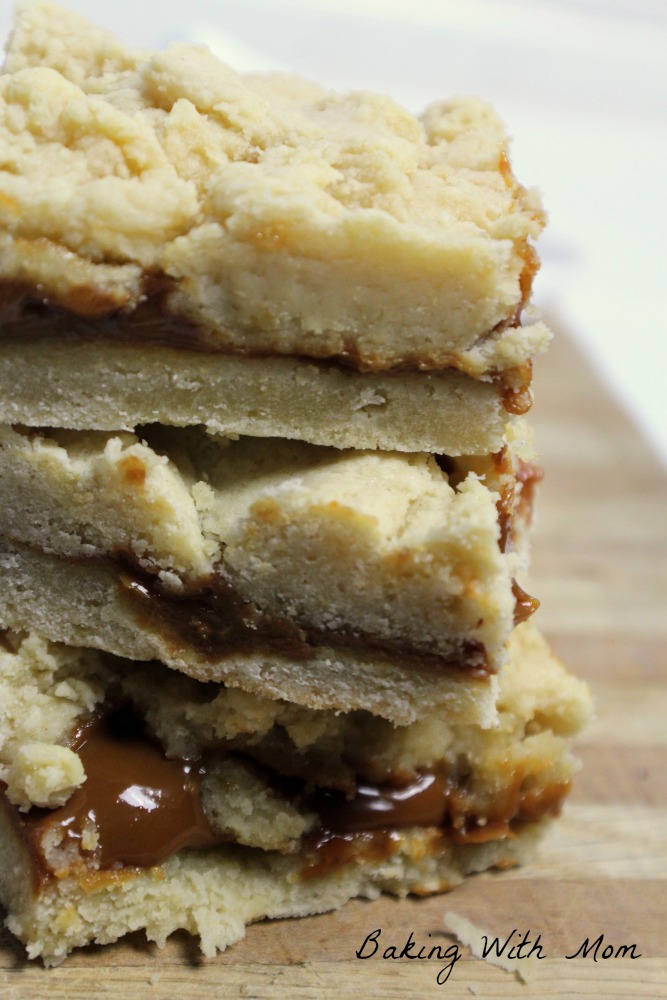 Caramel Shortbread Bars on a wooden cutting board