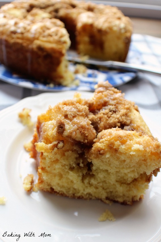 Brown Sugar Coffee Cake recipe on a white plate with a white frosting glaze