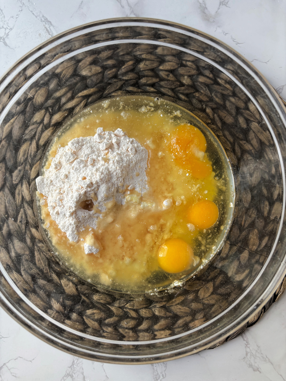 clear bowl with cake mix and eggs.