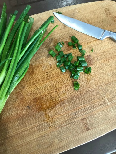 Chopped green onions on a cutting board