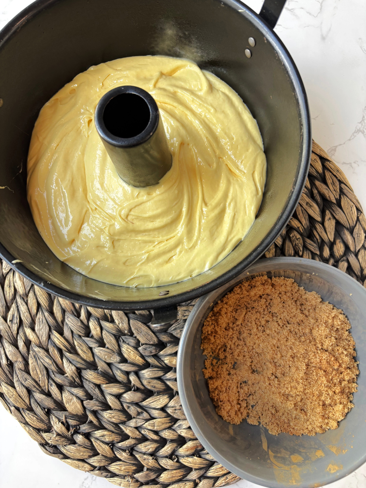 brown sugar in a gray bowl and uncooked coffee cake.
