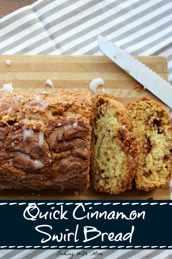 Quick Cinnamon Swirl Bread with frosting on top on a cutting board