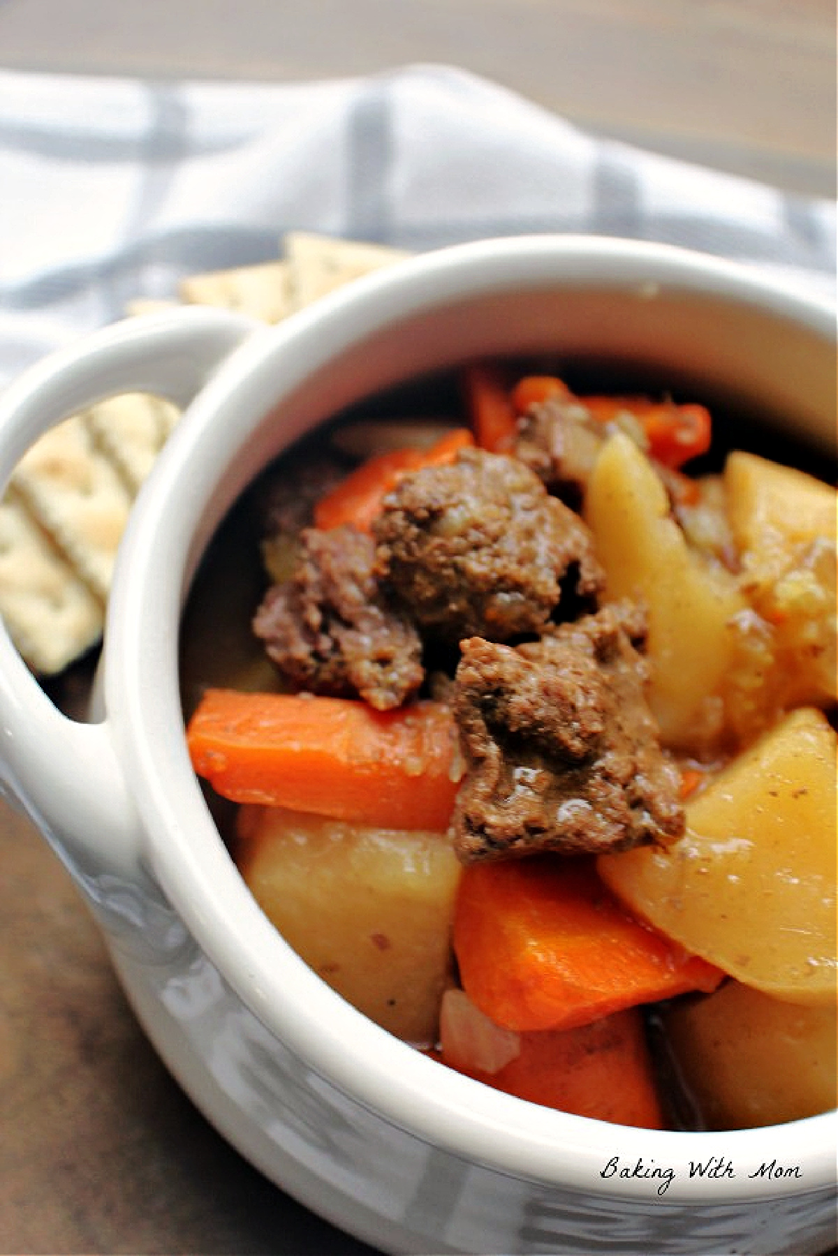 bowl of beef, potatoes and carrots in a bowl.