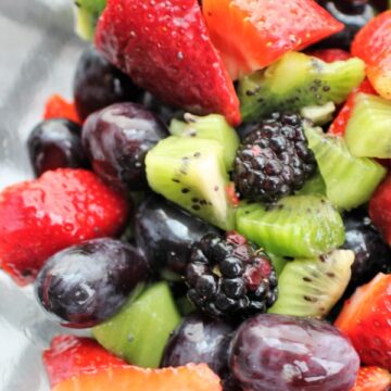 Kiwi, strawberry, grape and blackberry in a clear bowl