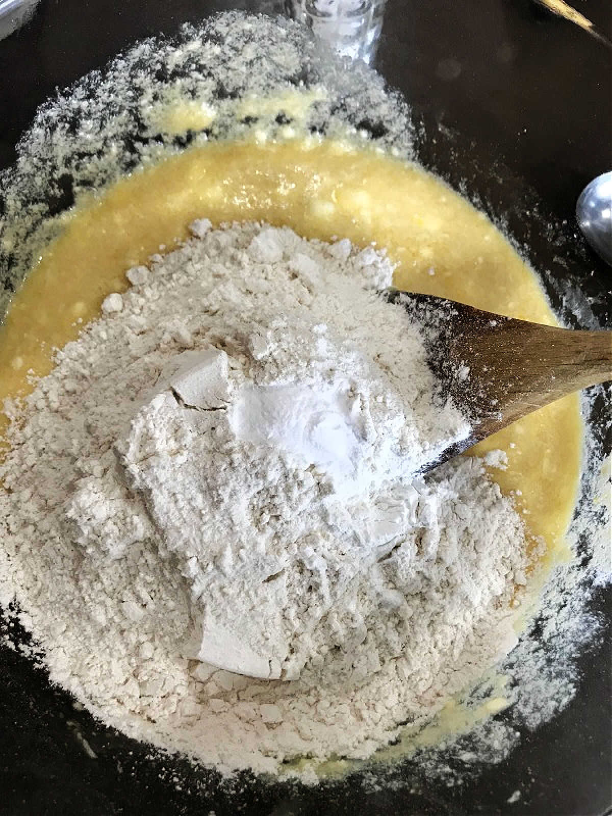 flour, baking powder and other ingredients in a clear bowl. 