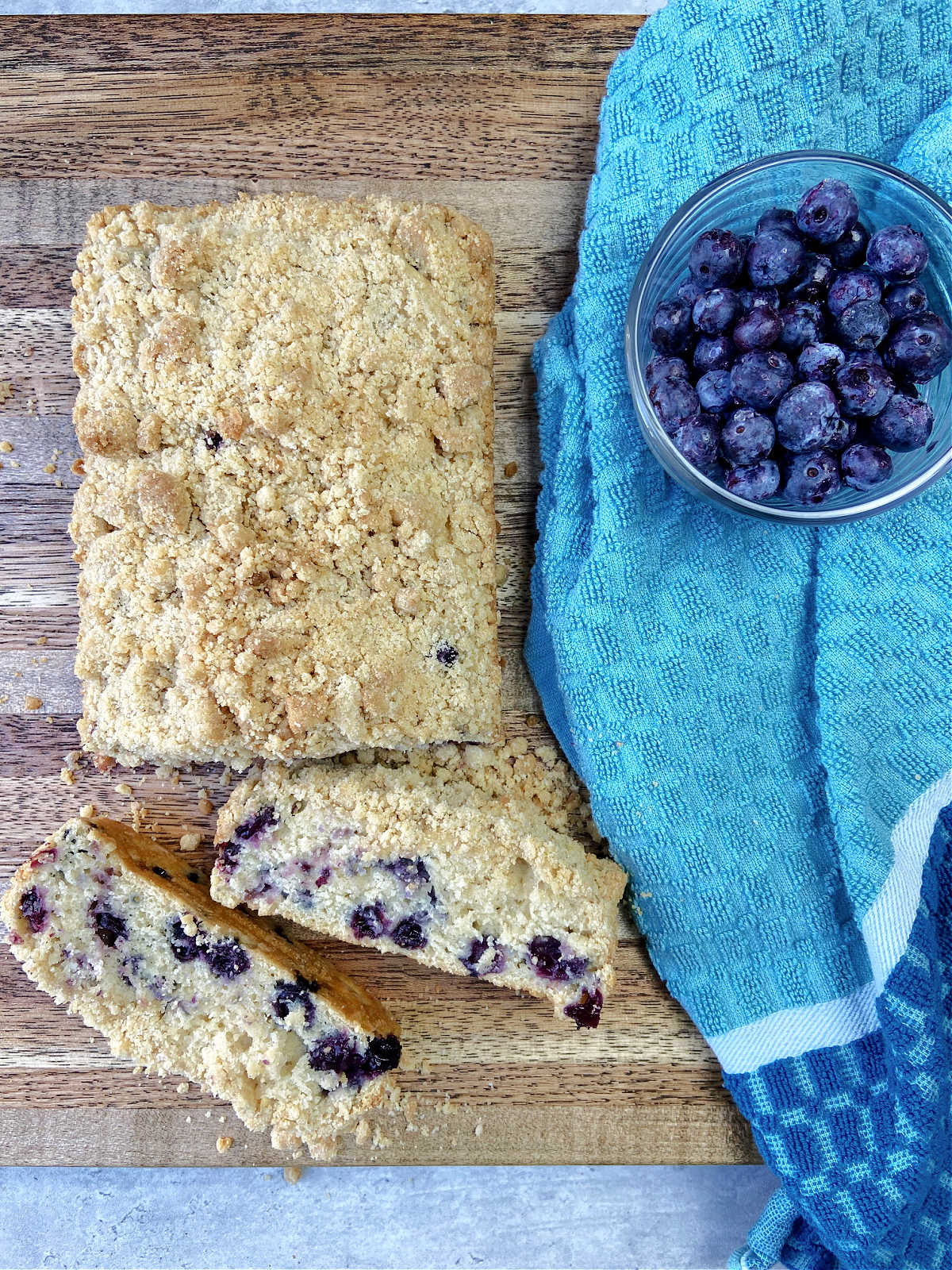 blueberry bread on a brown cutting board.