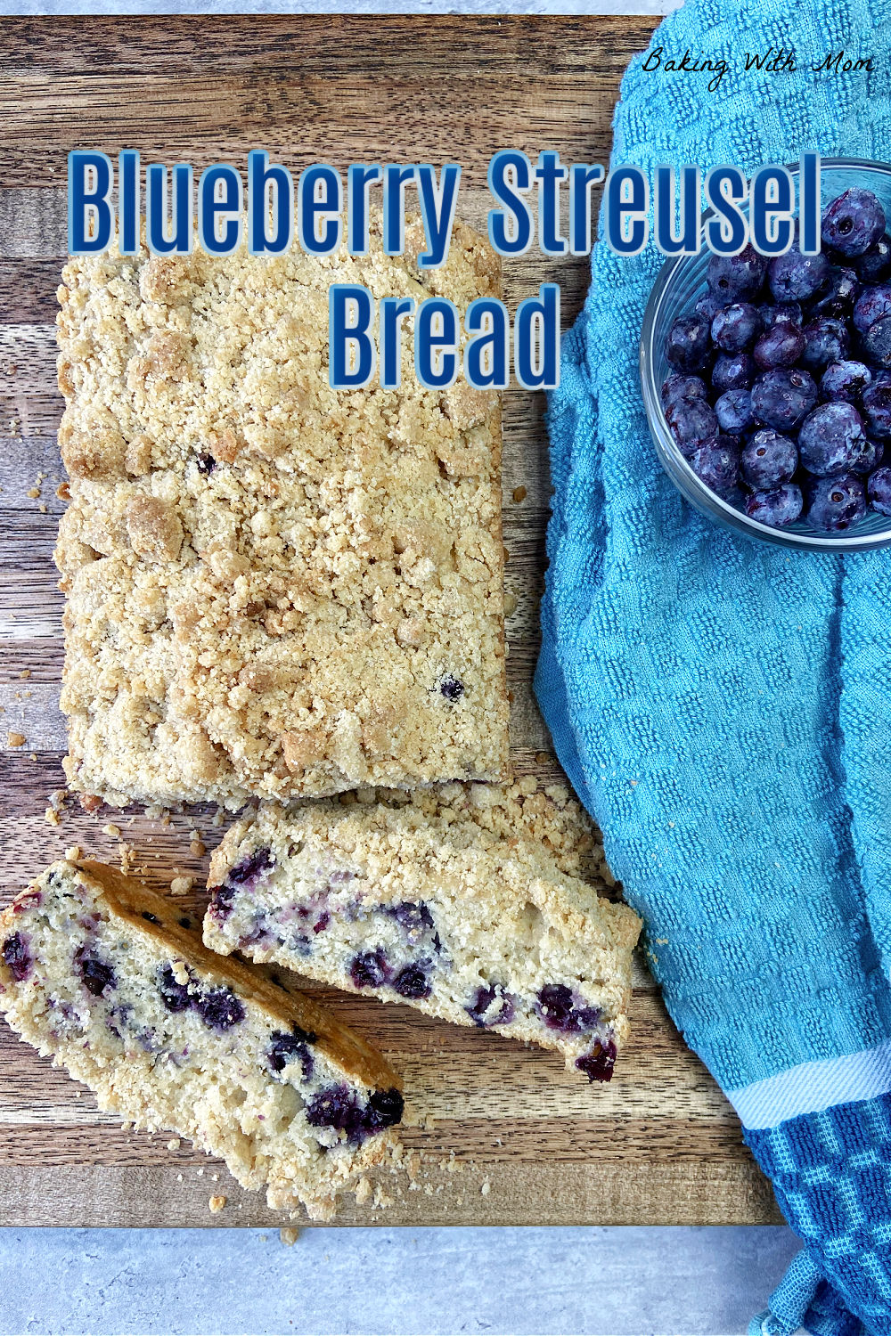 Blueberry bread on a cutting board with blueberries. 